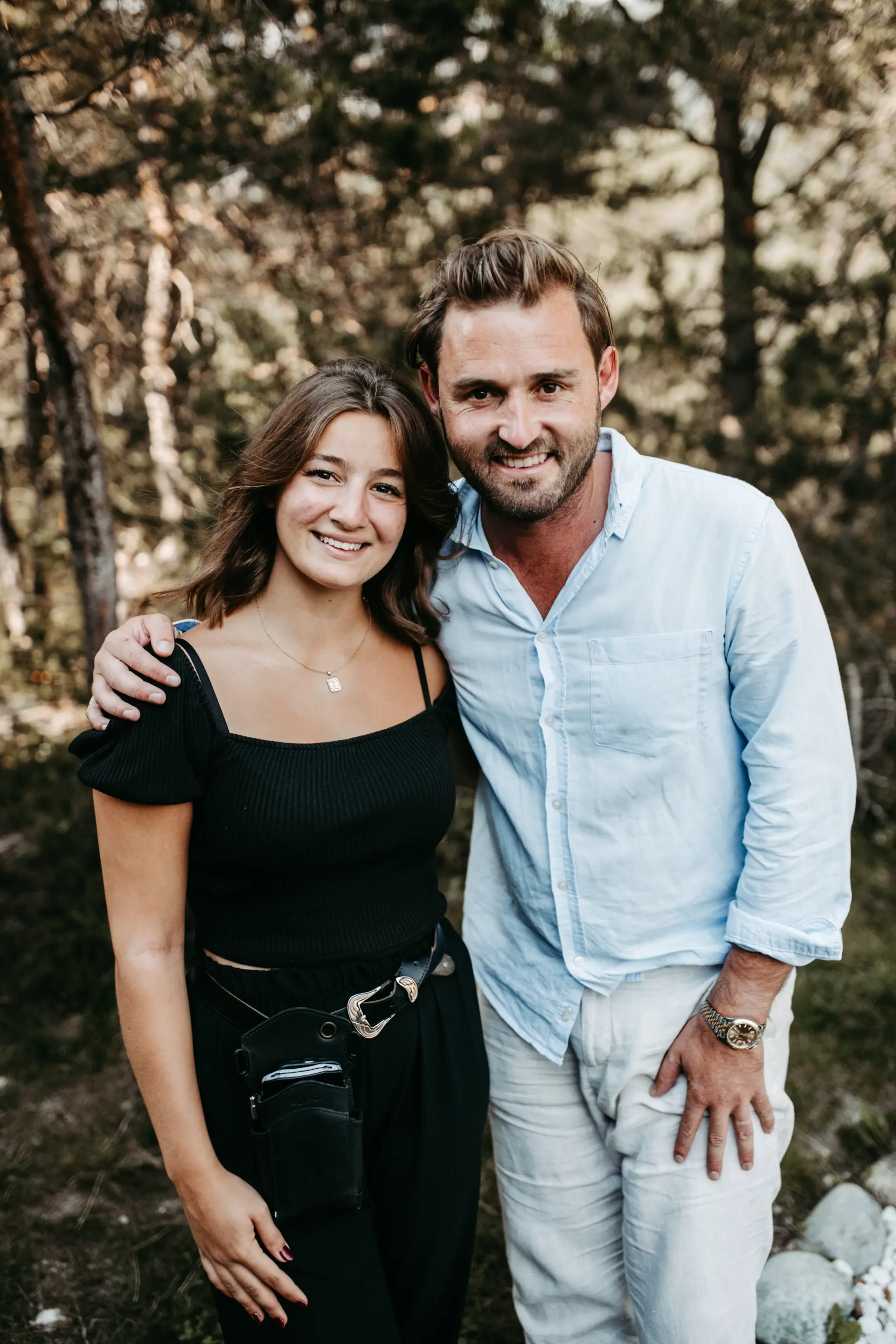 Smiling Stöttlalm team members posing together by the conifer forest on the Mieminger Plateau in Tyrol